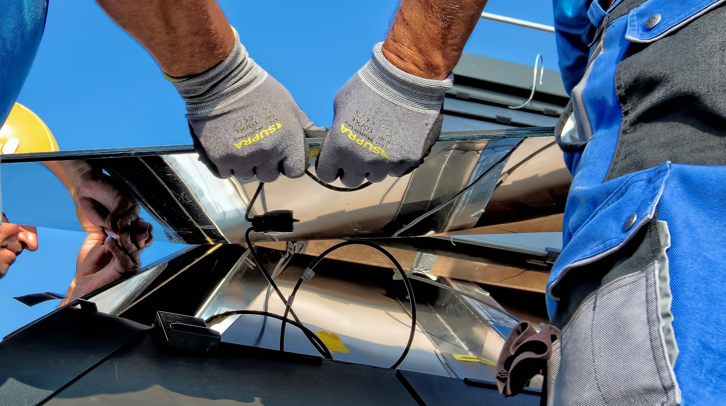 Technicians installing solar panels on site